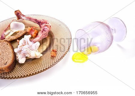The remains of food in the afternoon on a plate isolated on white background