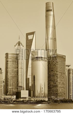 SHANGHAI CHINA - MARCH 25: Pudong district skyscrapers view from The Bund waterfront area on March 25 2016 in Shanghai China. Pudong is a district of Shanghai located east of the Huangpu River. Sepia toned photo