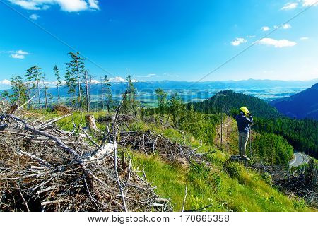 quad racer with helmet in highland landscape looking for his path