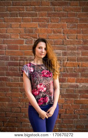 redhead girl background is a brick wall