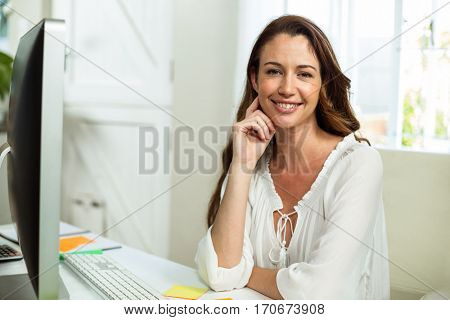 Portrait of businesswoman at desk in office