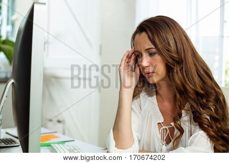 Frustrated businesswoman relaxing at desk in office in office