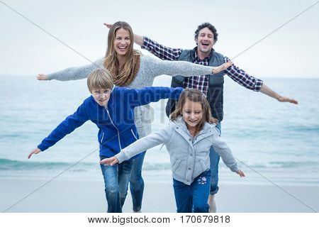 Cheerful children enjoying with parents at sea shore