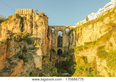 The popular historic landmark of spectacular Puente Nuevo, New Bridge, at sunset over Guadalevin River in town of Ronda, Andalusia, Spain.