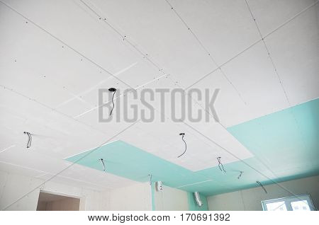 Ceiling construction details with electricity wire for lighting. Building gypsum plaster boards walls and ceiling. Ceiling Joists of Home Under Construction. Using Gypsum Board for Ceilings Section.