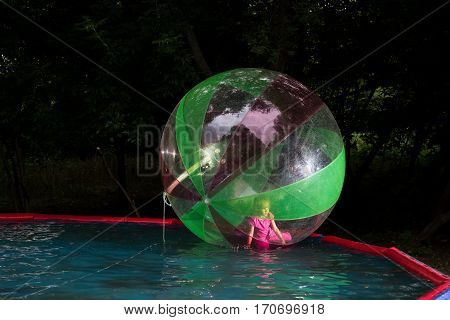 Little Girl In Zorb In The Pool