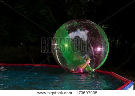 Little Girl In Zorb In The Pool