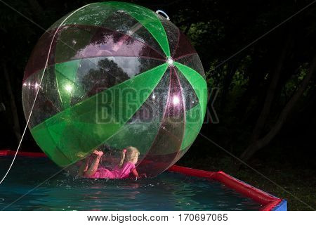 Little Girl In Zorb In The Pool