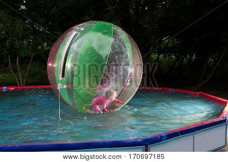 Little Girl In Zorb In The Pool