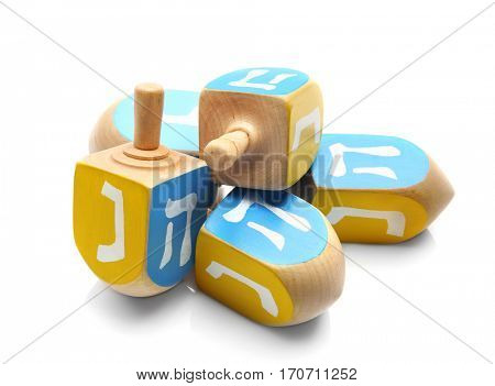 Wooden dreidels for Hanukkah on white background