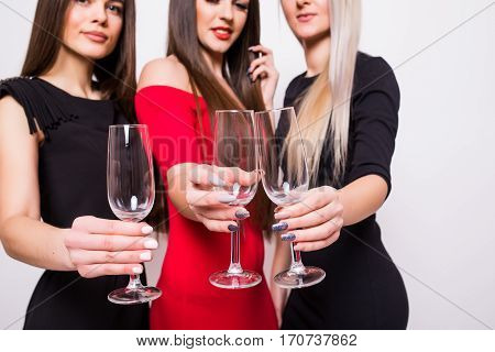 Smiling Young Women Celebrating With Empty Glasses On The Party