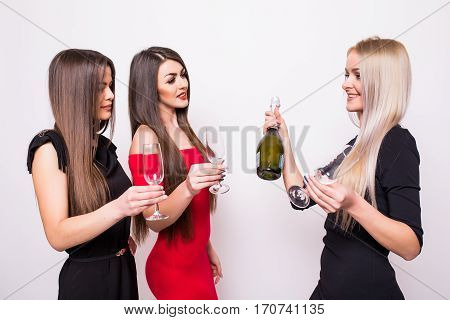 Three Smiling Young Women Celebrating And Drinking Champagne On The Party