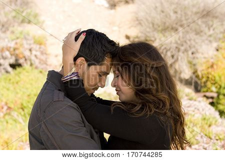 Portrait of a beautiful Hispanic couple laughing and smiling.