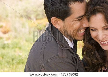 Portrait of a beautiful Hispanic couple laughing and smiling.