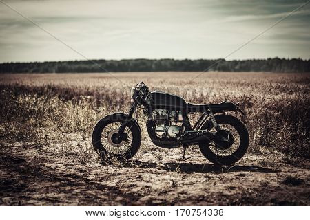 Vintage custom motorcycles in field.