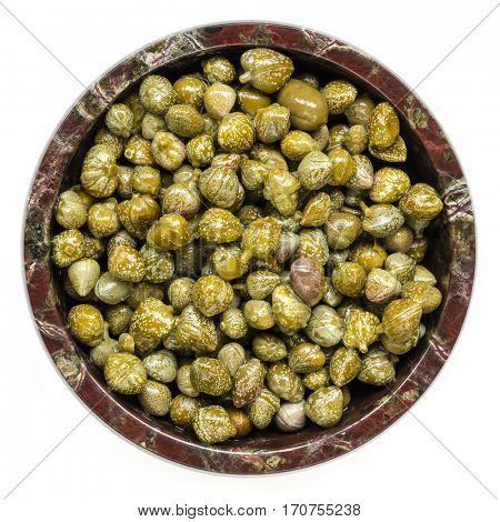 Capers in bowl.  Top view, isolated on white.  