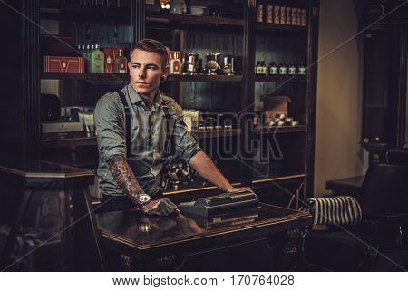 Professional hairstylist in barbershop interior