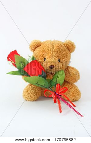 Brown teddy bears and red roses on a white background.
