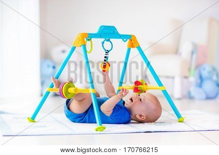 Baby Boy On Play Mat. Child Playing In Gym.