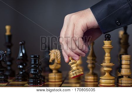 Game in chess. The chess player makes the move