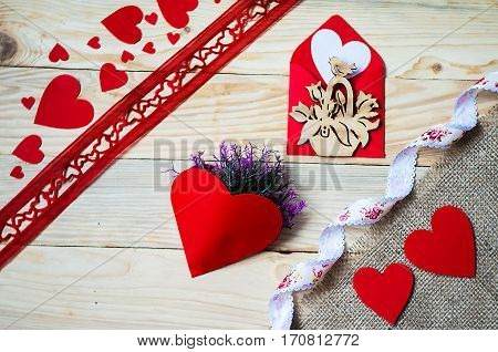 Hearts flowers ribbons on a wooden light background