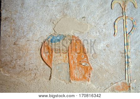 Remnent of the colourful carving of the Ancient Egyptian Prince Khaemwaset on the wall of his tomb in the Valley of the Queens Luxor Egypt. The tomb was built thousands of years ago and is now open to the public.