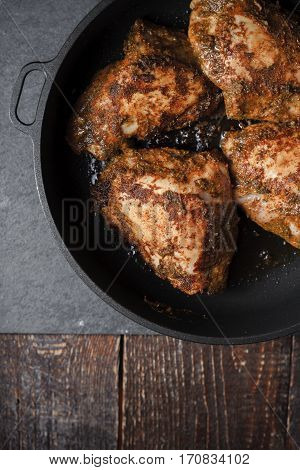 Butter Chicken in a sausepan on a slate closeup vertical