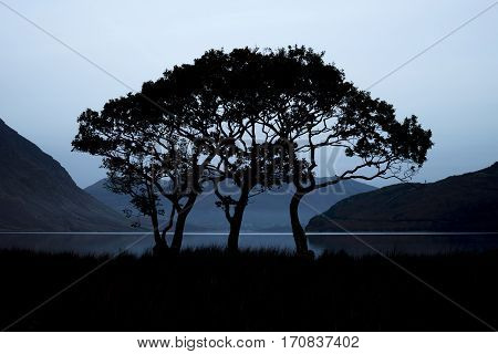 Beautiful Foggy Misty Autumn Sunrise Over Countryside Surrounding Crummock Water In Lake District In