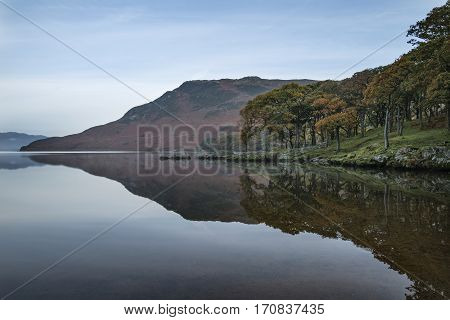 Beautiful Autumn Fall Landscape Image Of Crummock Water At Sunrise In Lake District England