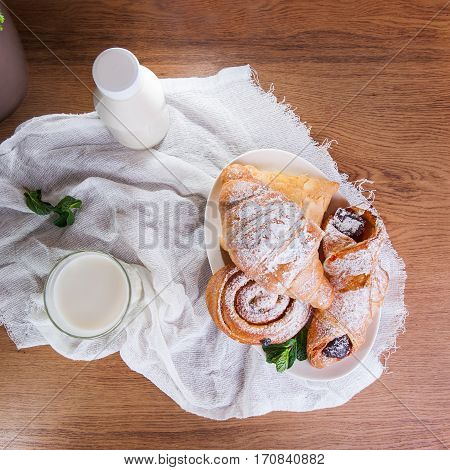 Top View Breakfast With Assortment Of Fresh Pastries And Glass Of Milk On The White Napkin. Selectiv