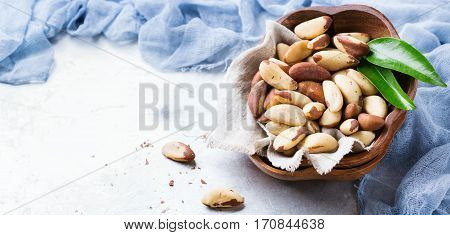 Still life, food and drink, heathy nutrition concept. Portion of organic healthy brazil nuts on a rustic table, selenium source. Copy space background
