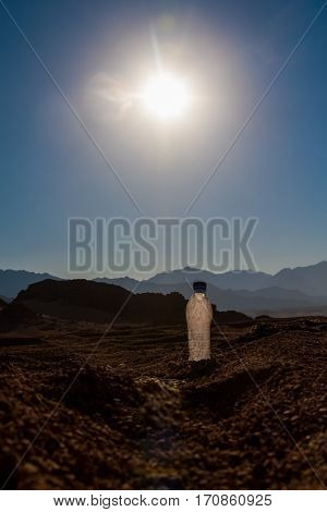 mpty crumpled plastic bottles of water abandoned on the desert.