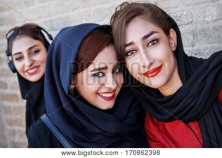 Iran Persia Isfahan - September 2016: beautiful local girls smiling at the old bridge in Esfahan.