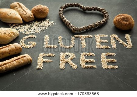 Gluten free bread for people that got special diet. Varios buns on black background health care concept.