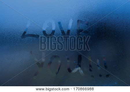 The words "I love you" written on the window