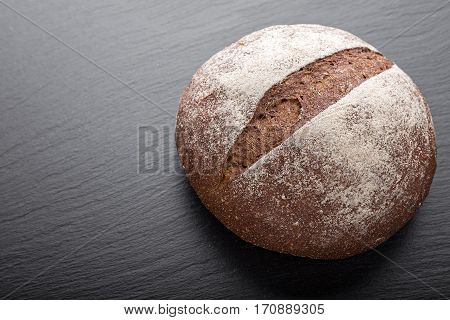whole fresh loaf of round rye bread with a crispy crust