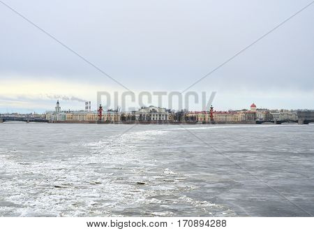 View of Frozen Neva River and Spit of Vasilyevsky Island in center of St.Petersburg at cloudy winter day, Russia.