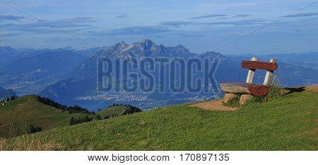 Bench on top of mount Rigi and distant view of mount Pilatus