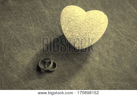 Love, Wedding And Valentine`s Day Concept. Beautiful Golden Wedding Rings And Glass Heart Selective