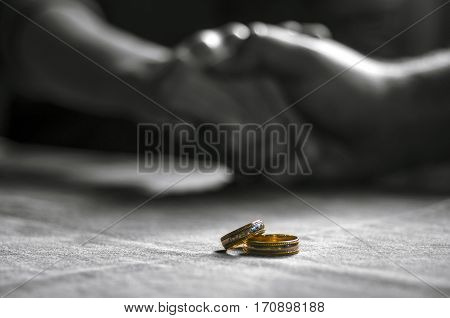 Love, Valentine`s Day And Wedding Concept. Two Wedding Rings With Man And Woman Hands Blurred In The