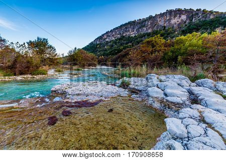 Fall Foliage on Trees Lining the Crystal Clear Emerald Waters of the Frio River at Garner State Park Texas.