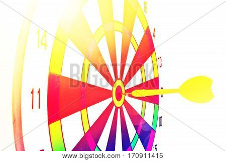Colorful darts at a target. Red dart hit the aim.