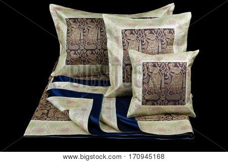 linens and pillows on a black background
