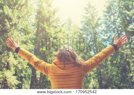 Girl enjoying in the nature with arms wide open.