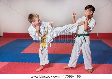 Children during training in karate. Fighting position active lifestyle practicing fighting techniques
