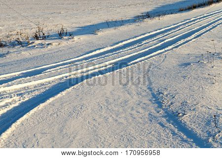 Snow-covered Road After The Last Snowfall. Roadway Small Size Which Traces The Track And The Wheels.