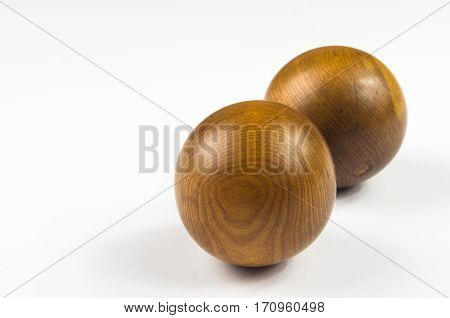 pair of wooden Chinese singing balls Baoding of health for hands on white background