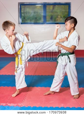 Children during training in karate. Fighting position active lifestyle practicing fighting techniques