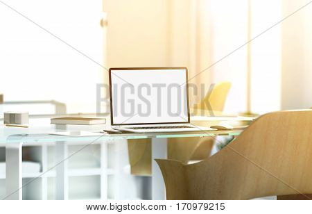 Blank laptop screen mockup in sunny office depth of field effect 3d rendering. Modern portable computer display mock up glass desk wooden chair blurred background with sunset. Coworking work room