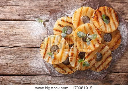 Fresh Pineapple Rings Fried With Mint On The Table. Horizontal Top View
